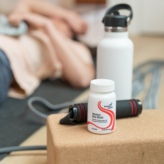 person in background working out bottle in front by waterbottle