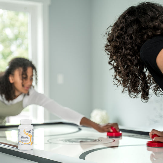 Image of two women playing air hockey