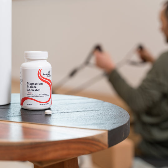 A person working out behind a Magnesum Malate Chewable Vitamins container