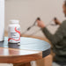 A person working out behind a Magnesum Malate Chewable Vitamins container