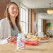 Woman sitting at a table eating a meal 