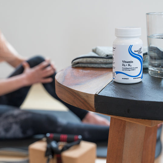 Person uses Vitamin D3 + K2 to support healthy bones.