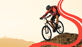 Image of man riding bike down hill
